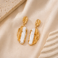 Auric pearl statement earrings with vintage gold sculptural details by CLINDE JADE
